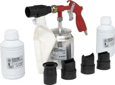 A set of pneumatic sandblasting tools and accessories, including a sandblasting gun, a collection bag, two bottles of cleaning fluid, and several nozzles, arranged on a white background.