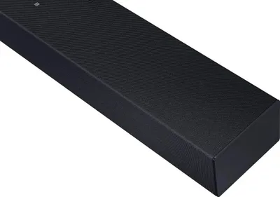 A close-up, angled view of a black soundbar on a white background.