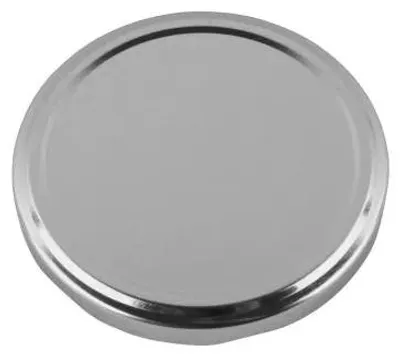 A close-up, top-down view of a silver jar lid on a light gray background.