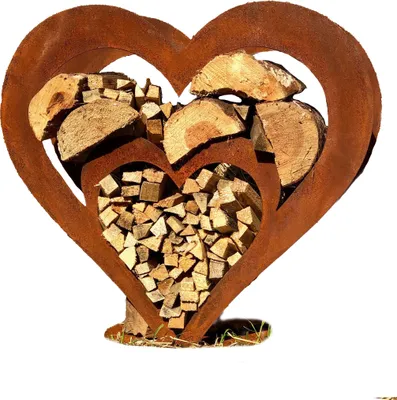 A metal heart-shaped firewood rack filled with logs, set against a white background.