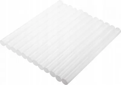 A pile of white hot glue sticks arranged diagonally on a white background.