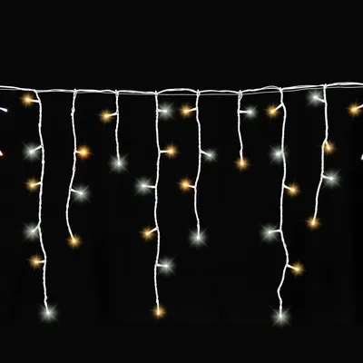 A string of icicle lights against a black background.