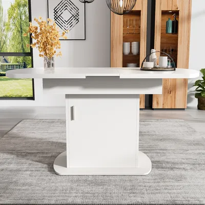 A white oval dining table with storage is shown in a dining room setting.