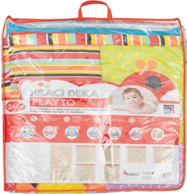 The image shows a colorful play mat for babies, folded and packaged in a clear plastic bag with a red handle. The packaging displays text and graphics related to the product's features and brand.