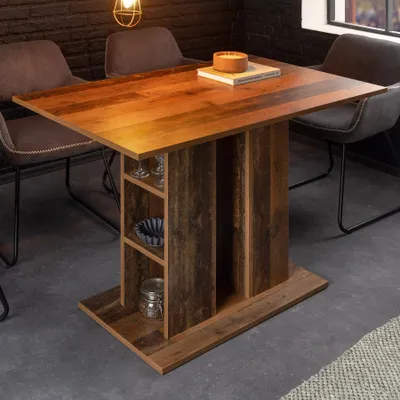 A dining table with chairs in a room with a brick wall.