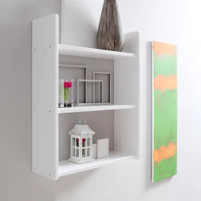 A white wall-mounted shelf with decorative items.