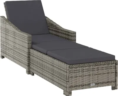 A grey rattan sun lounger with a dark grey cushion, shown from a diagonal angle on a white background.