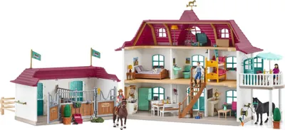 A toy horse stable and house playset with figures and accessories.