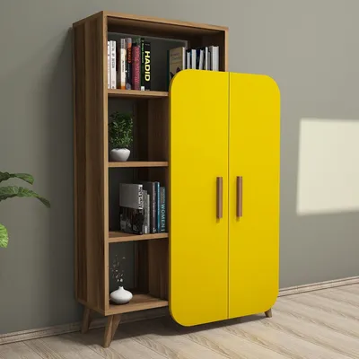 A bookshelf with a yellow cabinet on the right side, placed against a gray wall.