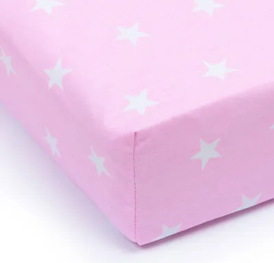 A close-up, angled view of a pink fitted sheet with white stars, isolated on a white background.