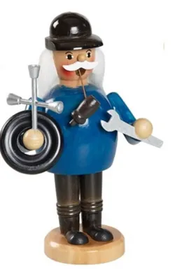 Räuchermännchen Mechaniker der Werkzeuge wie einen Schraubenschlüssel und einen Reifen hält.