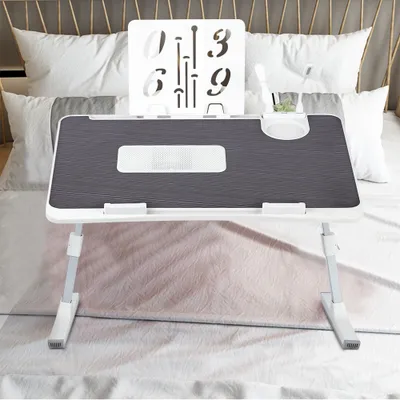 A laptop table is placed on a bed.