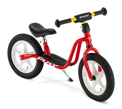 A red Puky balance bike with white wheels and black tires, seat, and grips, set against a white background.