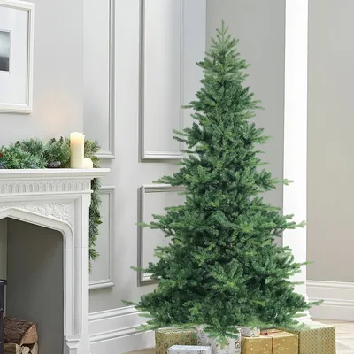 A decorated Christmas tree with gifts at its base, next to a fireplace.