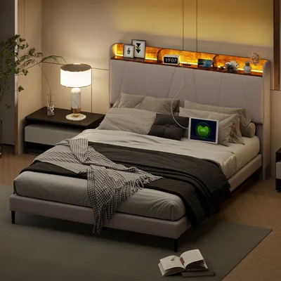 A bedroom scene featuring a bed with a headboard that has integrated lighting and shelves.