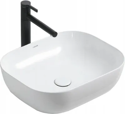 A white ceramic washbasin with a black faucet.