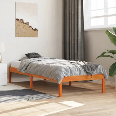 A bedroom scene with a wooden bed frame and bedding.