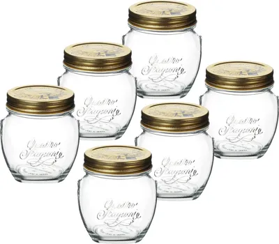 A group of six glass jars with gold lids, arranged in a staggered formation against a white background.