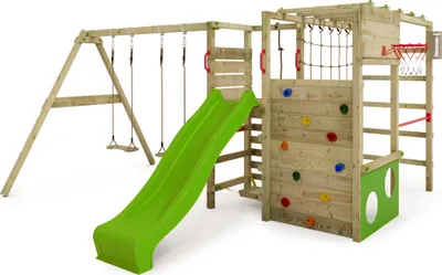 A wooden playground set with a green slide, swings, and a climbing wall.