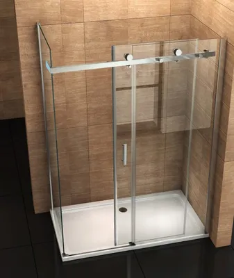 A modern glass shower enclosure with a sliding door, set against a tiled wall and dark floor.