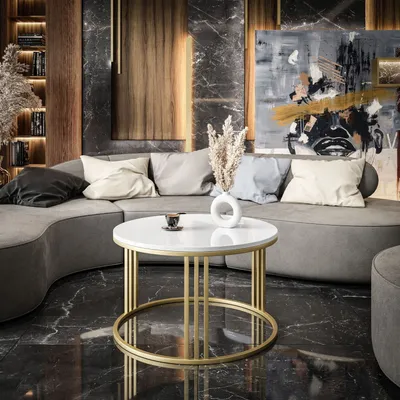 A modern living room with a curved sofa, coffee table, and abstract art.