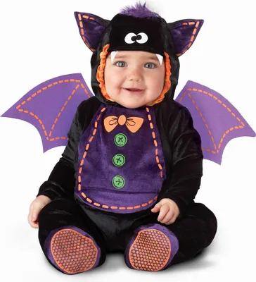 A baby wearing a bat costume.