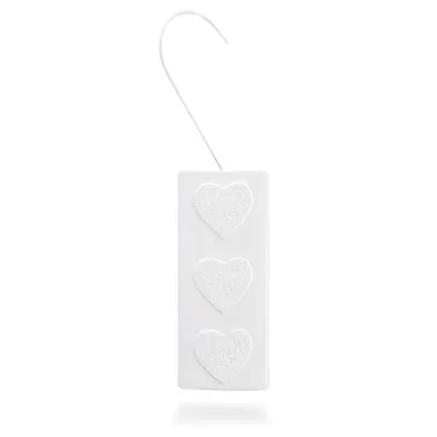 A white rectangular humidifier with three embossed hearts and a white hook for hanging.