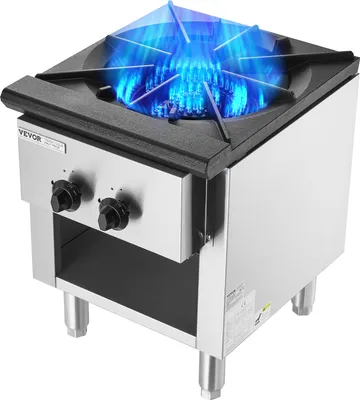 A commercial gas stove with a burner on.