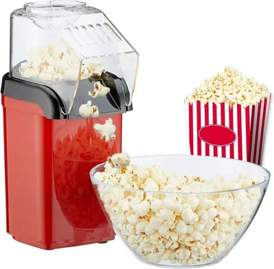 A red and black popcorn machine is shown with freshly popped popcorn in a clear bowl and a red and white striped popcorn box.
