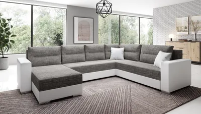 A modern sectional sofa in a living room with large windows.