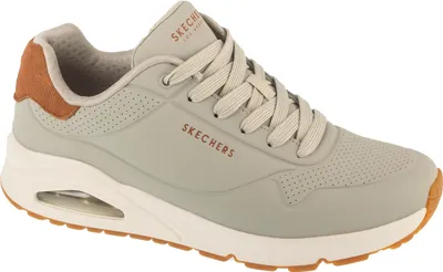 A side view of a beige Skechers Uno sneaker.