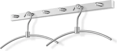 Two metal hangers on a white wall-mounted rack.