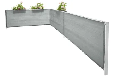 A grey balcony privacy screen with plants in planters on top.