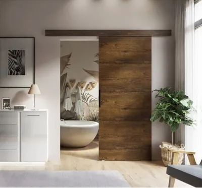 A modern bathroom with a sliding door, bathtub, and vanity.