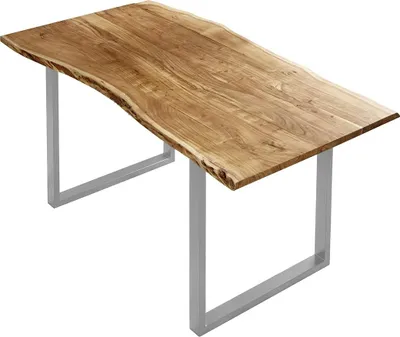 A wooden dining table with a live edge top and silver U-shaped legs, isolated on a white background.