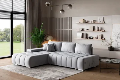 A modern living room with a large sectional sofa, shelves, and a window.