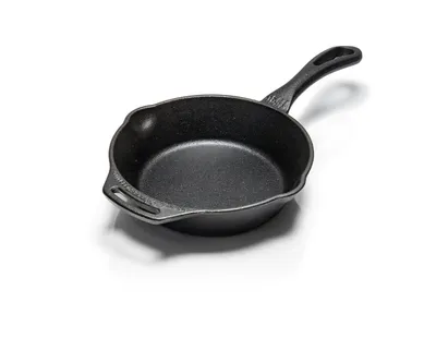 A cast iron skillet on a white background.