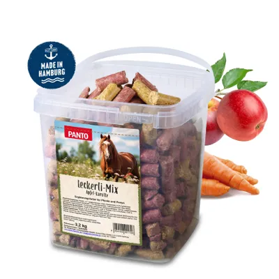 A bucket of horse treats with apples and carrots in the background.