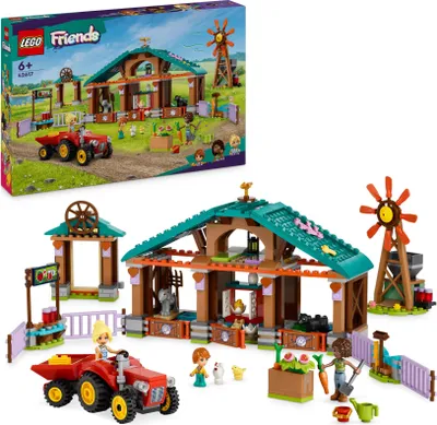 A LEGO Friends farm animal rescue set, including a barn, tractor, figures, and animals, displayed with its packaging.