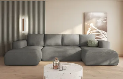 A modern living room scene featuring a large grey sectional sofa.