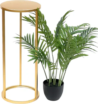 A gold plant stand next to a potted green plant.