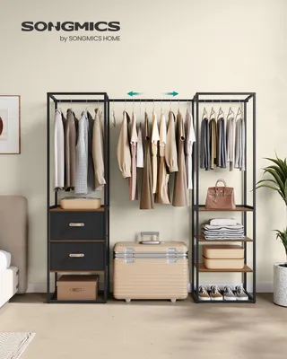 A bedroom scene featuring a SONGMICS clothing rack with clothes, drawers, shelves, and accessories.