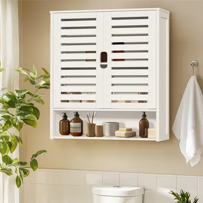A white bathroom cabinet with slatted doors and an open shelf below, containing various toiletries, is mounted on a light beige wall above a toilet.