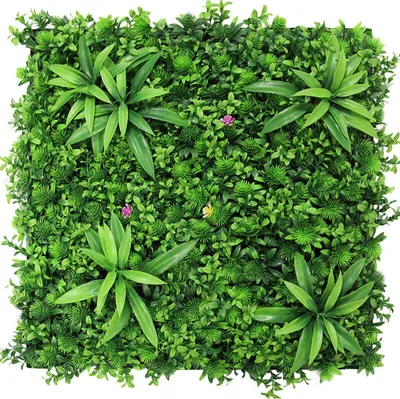 A close-up view of a modular artificial plant wall panel with various green foliage and a few small pink and yellow flowers.