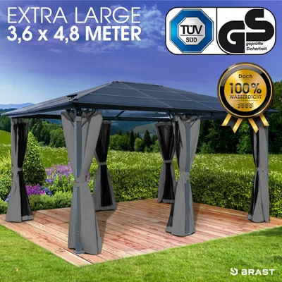 A gazebo set up on a wooden deck in a garden.