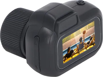 A small black digital camera is shown from a side angle, displaying a basketball game on its screen.
