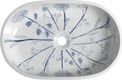 A top-down view of a white ceramic sink with a blue floral pattern.