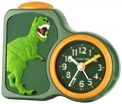 A close-up of a children's alarm clock with a dinosaur design.