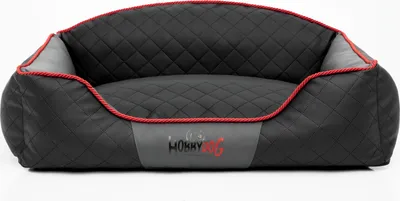 A black and gray dog bed with red trim, shown from the front on a white background.
