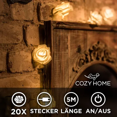 A string of rose-shaped LED lights is draped over a rustic wooden frame and brick wall.